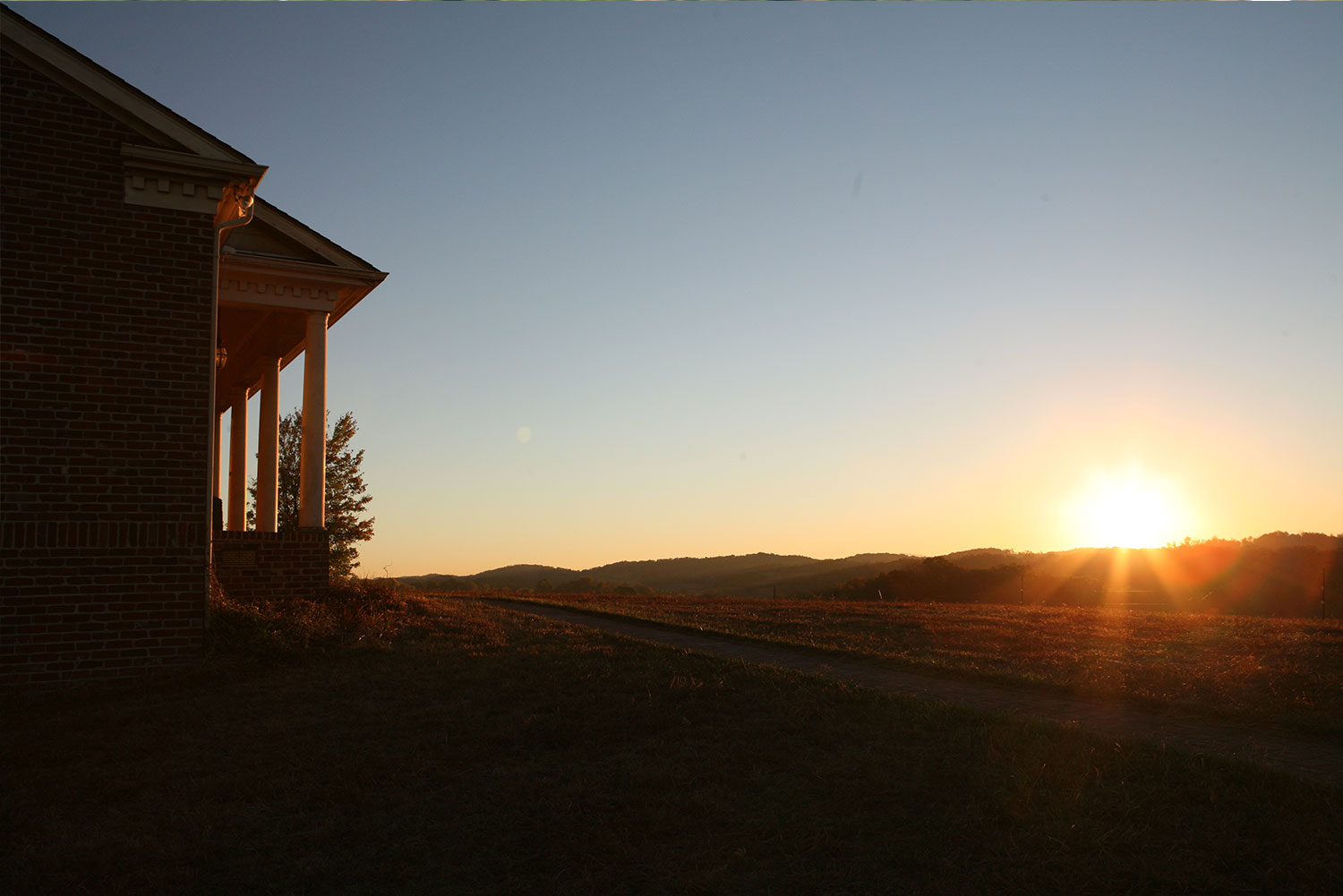 Sun rising over the ridge beside the clubhouse