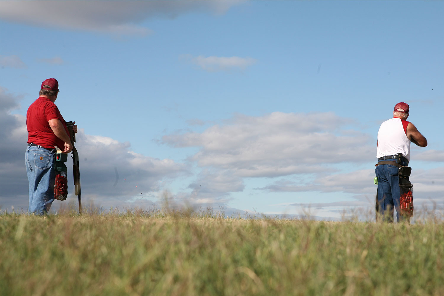 Two shooters on the field against a blue sky